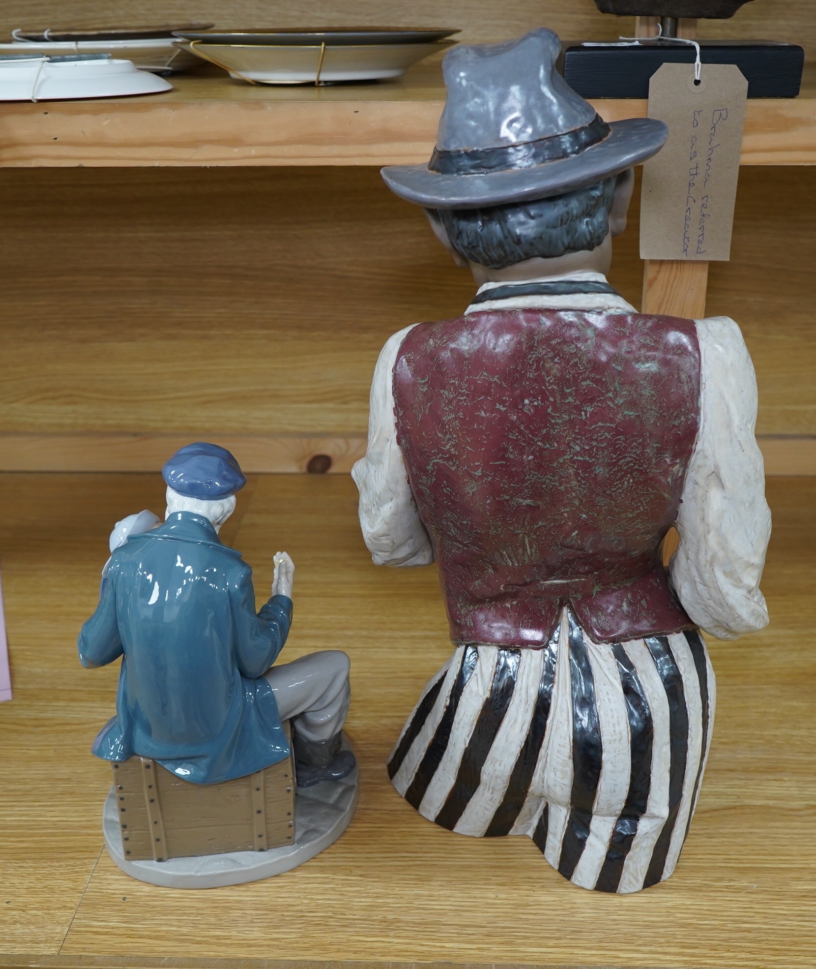 A Lladro figure ‘Playing the Blues’, 63cm high and a ‘Tall Yarn’ figure group of a fisherman and a boy. Condition - fisherman lacking the ship in his hand, otherwise good